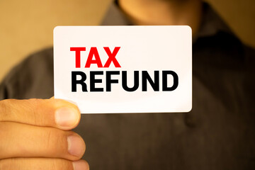 man holding a card with the inscription TAX REFUND