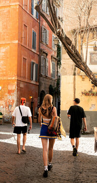 Three young people walking through the city of Rome