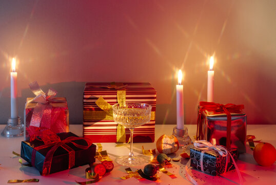 Christmas still life with gifts, candles and champagne