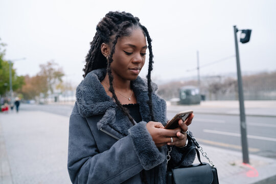 Young Black Woman using her phone