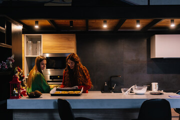 Sisters finishing baking traditional Christmas cookies