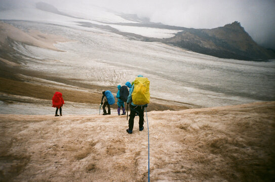 Hikers trekking in snowy mountains