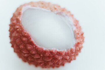 Lychee pink fruit with open shell and white pulp macro close up