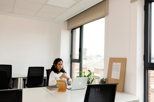 Young woman using laptop at office