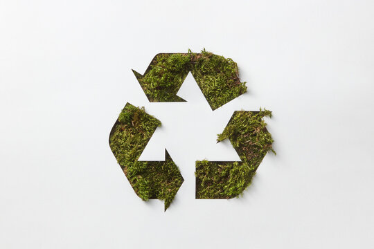 Recycle sign made of green grass