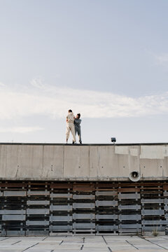 Friends climbin a wall helping each other