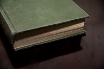 green book on brown wooden table