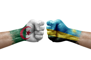 Two hands punch to each others on white background. Country flags painted fists, conflict crisis concept between algeria and rwanda