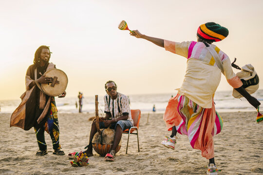 African friends playing music and dancing