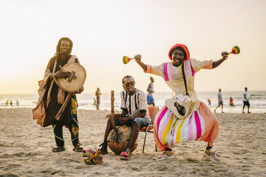Traditional African group playing music on shore