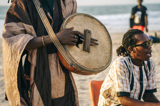 Black musician playing melody on gongomah