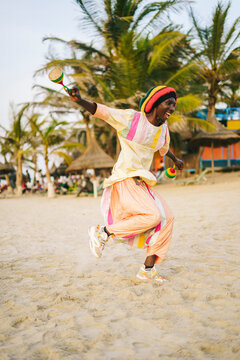 African man dancing with traditional rattles
