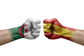 Two hands punch to each others on white background. Country flags painted fists, conflict crisis concept between algeria and spain