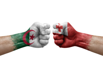 Fototapeta premium Two hands punch to each others on white background. Country flags painted fists, conflict crisis concept between algeria and tonga