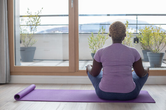 yoga at home, black woman with short hair meditating