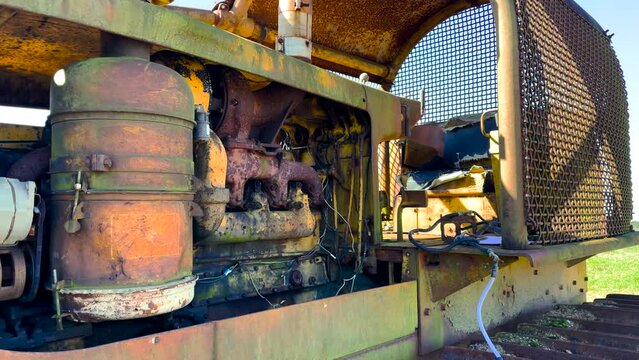 Motor close up Old antique rusted vintage abandoned tractor on a farm inoperable
