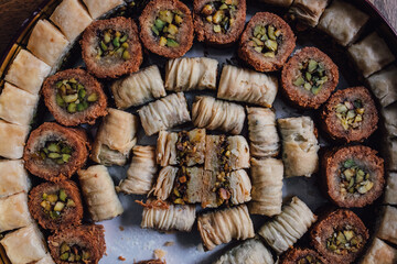 assorted circular tin of middle eastern baklava filo dough pastry sweets	