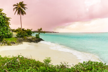 Holguin province, Cuba, gorgeous view on Guardalavaca beach with stormy turquoise ocean and pinkish sunset sky background 