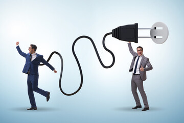 Businessman being powered by electric power