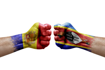 Two hands punch to each others on white background. Country flags painted fists, conflict crisis concept between andorra and eswatini