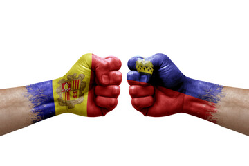 Two hands punch to each others on white background. Country flags painted fists, conflict crisis concept between andorra and liechtenstein