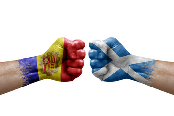 Two hands punch to each others on white background. Country flags painted fists, conflict crisis concept between andorra and scotland