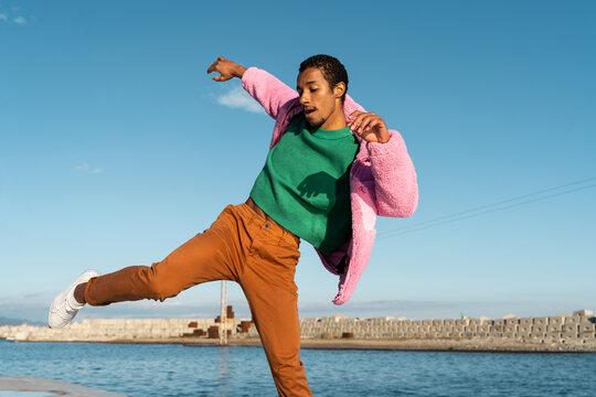 Portrait of fashion  young man dancing outdoors