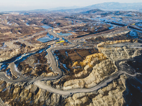 Open Pit Mine. Coal Mining, Aerial Drone View. Trucks Carry Ore. Mining Industry.