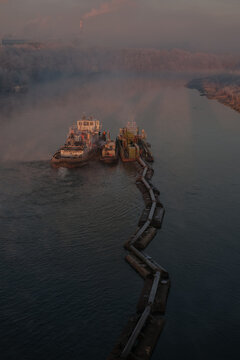 Barges extract sand on the river