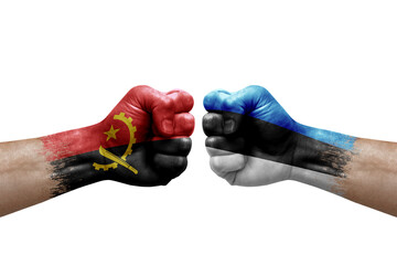 Two hands punch to each others on white background. Country flags painted fists, conflict crisis concept between angola and estonia
