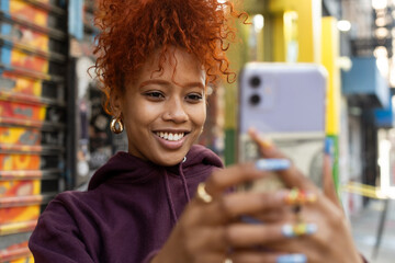 Woman smiling and looking at camera phone