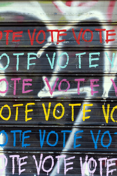 Wall with graffiti that says VOTE