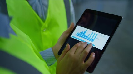 Factory workers analizing graphs checking data on tablet screen hands closeup