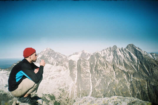 Male traveler playing harmonica in highlands