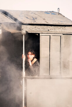 A teenage girl gazing outside from a steam loco !