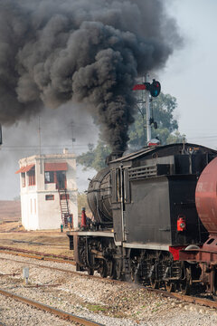 Steam Locomotive emitting heavy smoke before a start.