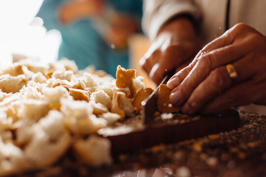 Anonymous man cutting bread