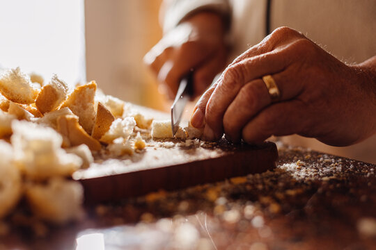 Anonymous man cutting bread