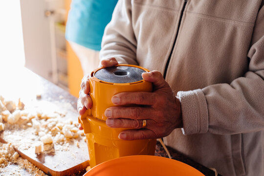Anonymous man preparing bread for grating