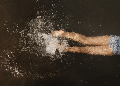 Anonymous female calmly swimming in lake water