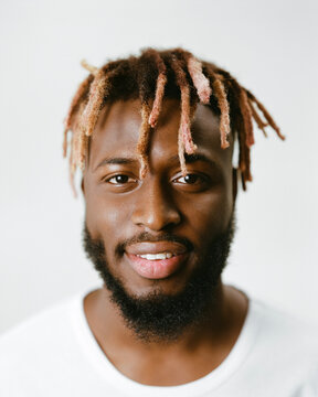 Portrait of a smiling man with dreadlocks