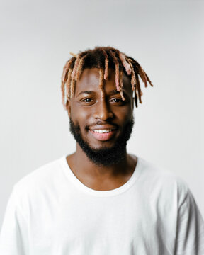 Portrait of a smiling man with dreadlocks