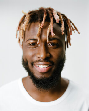Portrait of a smiling man with dreadlocks