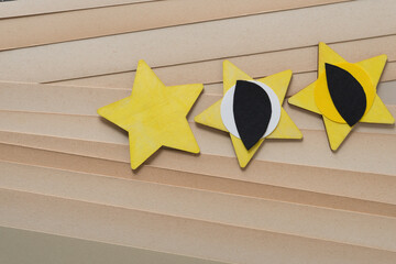 three stars with paper objects on old, faded paper 