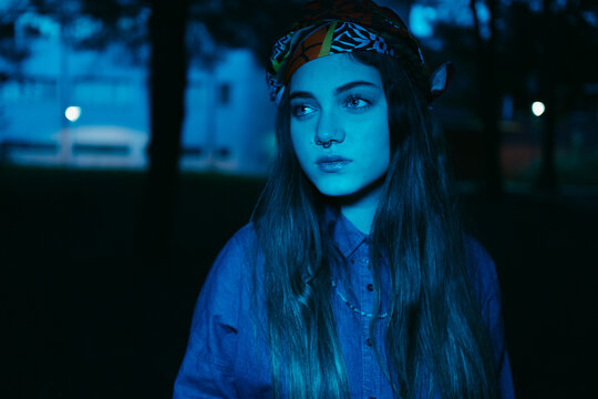 Evening portrait of trendy woman with blue filter