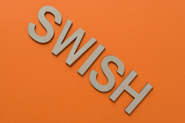 sign with the word "swish" on a paper surface