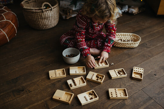 Toddler learning how to count with wooden toy