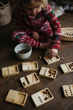 Toddler learning how to count with wooden toy