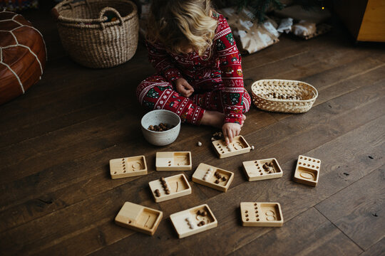 Toddler learning how to count with wooden toy