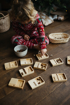 Toddler learning how to count with wooden toy